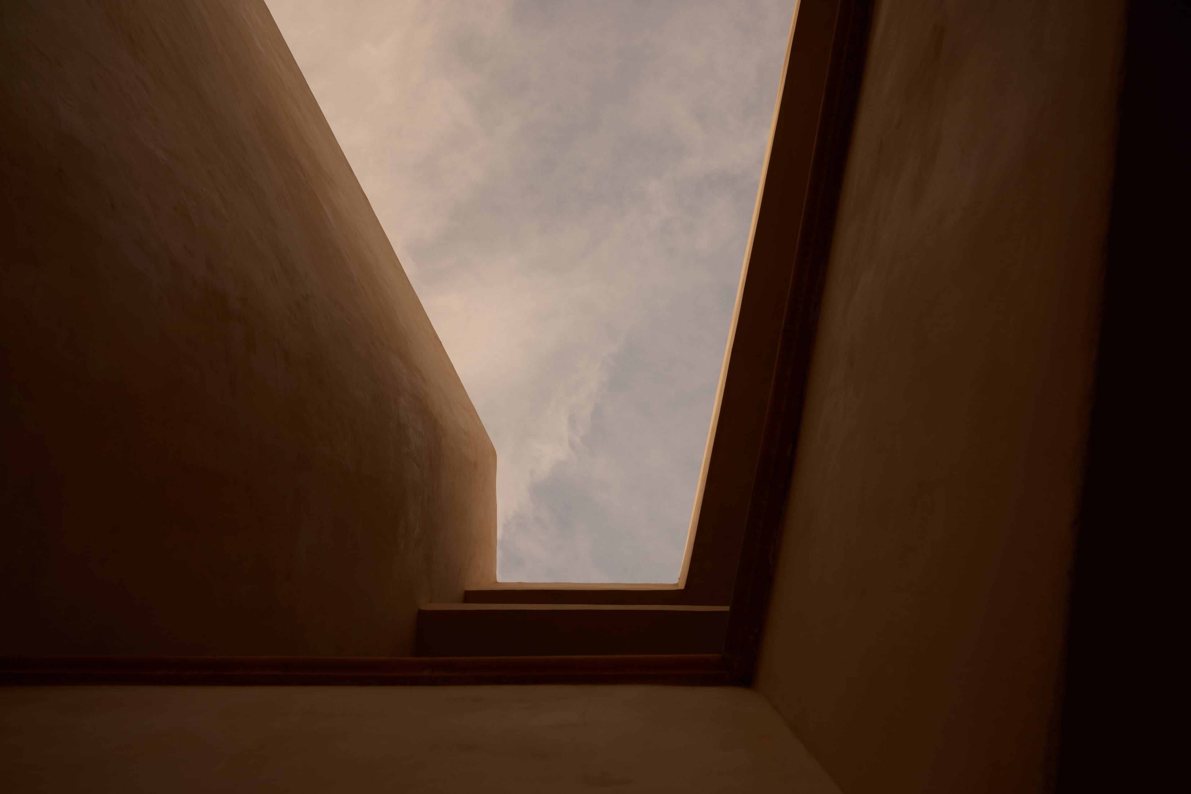 Sunlit plaster stairwell with skylight